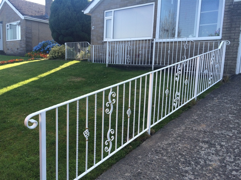 Wrought iron fence ramp railings in white